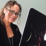 Portrait of RevOps speaker Sandy Robinson smiling next to laptop